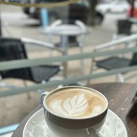 Latte by the window  at Pip & Oat in Llandudno