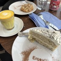 Turmeric latte with cakes and cookies.   at Pip & Oat in Llandudno