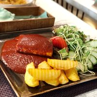 Tofu steak with fried potatoes and spicy tomato sauce  at Vegafe - Totoriu g. in Vilnius