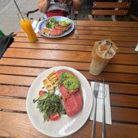 Avocado toast with beet root hummus, iced coffee with oat milk and fresh orange juice at Lara Cafè Budapest  in Budapest