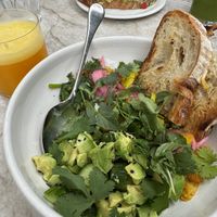chickpea scramble with fresh squeezed oj, in the background is the avocado toast which is also vegan   at Great White in Venice