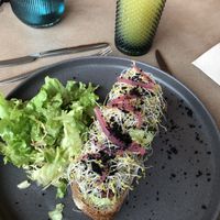 Green toast and pineapple juice  at Boshq  in Almada