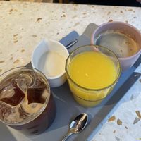 Iced americano, americano, fresh OJ, oat milk   at Elias Coffee Shop in Prague