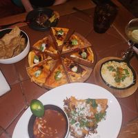 Chicken quesadillas, creamed corn, and birria tacos at Sentir in New York City