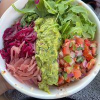 Burrito bowl with rice + beans + tempeh + arugula + pickled onions + purple cabbage + guaca + pico   at Poppo's Taqueria in Anna Maria