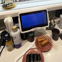 Order from the screen and your order comes on the sushi bullet train and stops in front of you  at Uobei in Tokyo