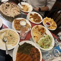 Houmous, pumpkin bolanee, spinach, pumpkin, kidney beans and aubergine curries, bread and water  at Ariana 2 in North West London