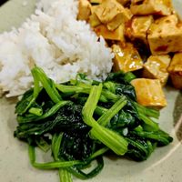 Mapo tofu, steamed spinach, and rice at Chinese Bao Buns in Tel Aviv