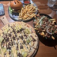 Vegan cheeseburger pizza, vegan burger, and vegan jackfruit fries   at Fortress Sydney in Chippendale