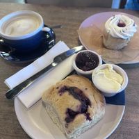 Raspberry and dark chocolate scone. Victoria sponge cupcake. Pistachio latte!  at Hustle in Belfast
