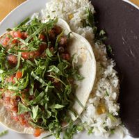 Pura vida (plantains) with rice and beans  at Taco Ocho in Richardson