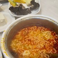 Tom yum broth with ramen at Homey Hot Pot in Bloomington