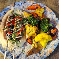 Kebab skewers, mashed potatoes, grilled vegetables, tahini, harissa sauce at 269 Two Six Nine in Frankfurt