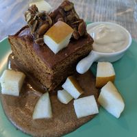 Warm Gingerbread dessert: gingerbread cake, rum sauce, fresh pear, pumpkin brittle, coconut whip at enVie A Vegan Kitchen in Halifax