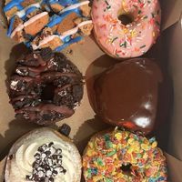 Sweet & Simple: "A box of pure happiness from Voodoo Doughnut! 🍩✨"
Indulgent: "Can't decide which one to try first, so I guess I'll just eat them all. 🤤" at Voodoo Doughnut in Chicago