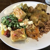 Vegan buffet items: “chicken” curry, Salad, collards, peas and rice, sweet potato casserole, corn bread  at Mango's Caribbean Cookhouse in Huntsville