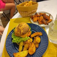 Veggie burger with vegan cheese, sweet potato wedges and complementary bread at Middle Bistrot in Milan