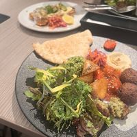 Plantmore signature plate with falafel. Avo toast in the background. All tasty!  at plant more in Tokyo