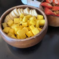 PEANUT BOMBA BOWL
Acai topped with homemade peanut butter, homemade walnut granola, mango, and banana (peanut butter is under the fruit)  at Projeto Acai - SZR  in Dubai