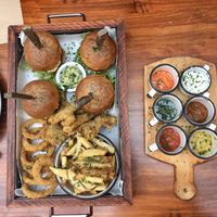 Plate for 4: burgers, onion rings, fries, fried portobello mushrooms, various dips at Green Point in Cusco