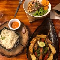 Ceviche and the unpleasantly salty lomo saltado that was served with rice on a different plate for some reason.  at Green Point in Cusco