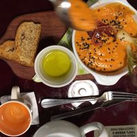 Creamy tomato soup with bread and olive oil. No dairy! at Green Point in Cusco