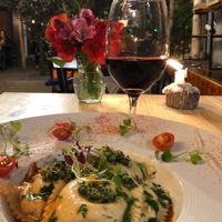 The pasta stuffed with mushrooms, on a rustic tomato sauce topped with pesto. My favourite!! The Spanish red was likewise amazing. A great pair! at Green Point in Cusco