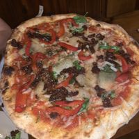 Vegan flatbread with added vegan cheese. Swapped mushrooms and olives for peppers and sundried tomatoes. Added spinach  at Flatbread Company in North Conway