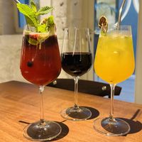 Strawberry sangria, red wine, and passion fruit spritz mocktail  at roots in Porto