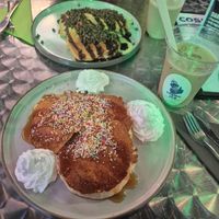 Vegan pancakes with maple sirup, sprinkles and whipped cream (front). Vegetarian pancakes with chocolate sauce and chocolate chips (back). at Cosmic Jo's Galactic Trading Outpost in Norwich