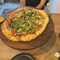 One side with “chorizo” pineapple and jalapeño, the other with “chicken” pesto   at Marcello's Plant Based Pizza in Cabo San Lucas