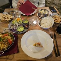 From left to right: Vegetarian naan, biryani, empty samosa plate, vegetarian curry, rice, paratha at Chakra in Tallinn