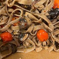 Whole wheat fettuccine with Aglio e Olio sauce, red onions, cremini mushrooms and grape tomatoes at Pasta Garage in Lexington