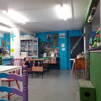 Green counter to place food and drink orders, to the left is the condiment etc table. at Doncaster Skate Co-operative in Doncaster