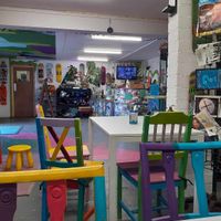 Colourful chairs and the magazine rack to the right with Zines and magazines such as Animal Aid's Outrage. at Doncaster Skate Co-operative in Doncaster
