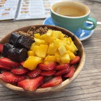 Acai bowl with brownie pieces, granola, mango and strawberries, with turmeric latte  #Veganuary at Projeto Acai - Dubai Marina in Dubai