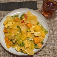 Tofu and sweet potato curry. Iced tea with peach and hibiscus. at The Little Hanoi in Brasov