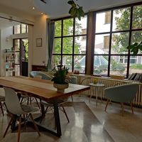 Inside with a view of the garden at The Light - Tea House in Prague