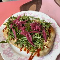 Langos with v-cheese, ketchup, arugula and pickled onion   at Safe Space in Prague