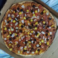 Vegan pizza (no cheese) with pineapple, tomato, onion and olives at Pizza Nut in Utila