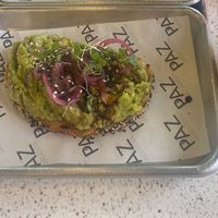 Avo toast breakfast option. Wedded sourdough with avocado, pickled red onions, sesame seeds and salad shoots. So yummy! at Paz Coffee & Kitchen in Port Of Spain