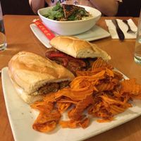 Sausage Sub -- House-made vegan sausage with molé sauce, sautéed peppers & onions and sweet potato chips on the side  at Great Sage in Clarksville