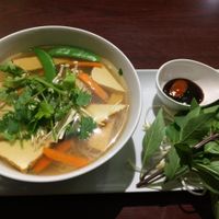 [image description: a colour photo of a bowl of pho on a long plate. beside the bowl is a small bowl with sauces and a bunch of basil. end description.]

Vegetarian Pho - $8.75 (as of October 2014)

absolutely delicious at Veggiebowl in Vancouver