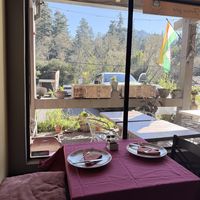 View of mountains and trees out the window  at Arti Cafe in Lagunitas-forest Knolls