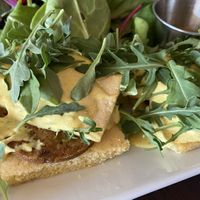 Southern benedict - cornbread, sausage patty, tofu, creole hollandaise sauce and arugula 💯 at Tree House in St Louis