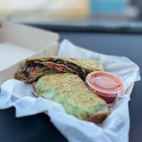 Shroom Crunch Wrap
A crispy grilled tortilla filled with mushrooms, onions, peppers, spinach, salsa, and cilantro lime with a crunch tortilla in the middle. Served with hot sauce. at Shroomlicious Meals in Memphis