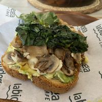 Mushrooms, avocado, spinach, vegan cheese on toast!  at La Biodega Cafe in Mancora