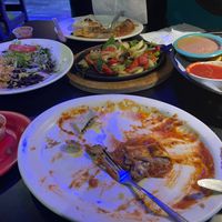 the bean burrito in the foreground went fast! Nice sauce. Rice & black beans far left. refried vegan pinto beans & salsa far right. Fajitas in the middle.  at Rio Mexican Cuisine in Burnsville