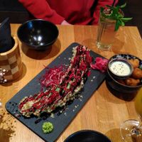 Colourful tempura-fried sushi, deep-fried vegan prawns with avocado sauce and mango-coconut drink. at Bodhi Vegan Living - St George in Hamburg