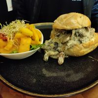 Toasted bread roll filled with delicious vegan creamy mushrooms and a mango salad at Arbol de Seda in San Jose